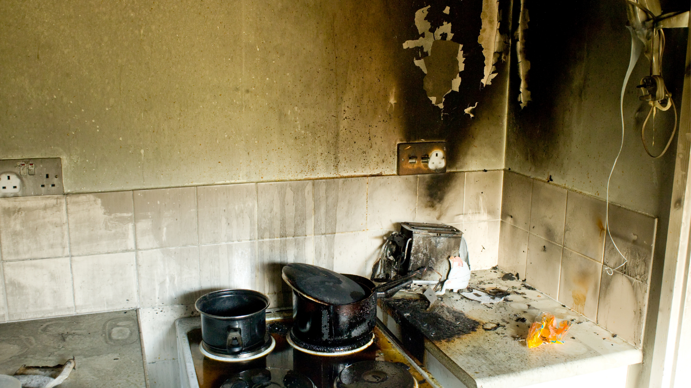 a badly smoke damaged kitchen covered in scorch marks.